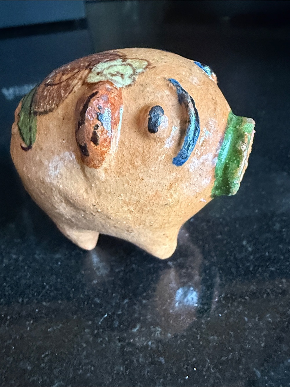 A hand-painted Mexican terracotta pig folk art figurine from Tlaquepaque.